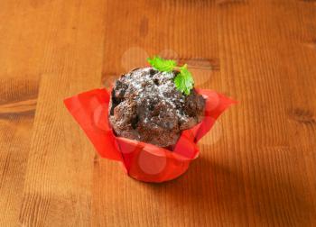 Double chocolate cupcake wrapped in red paper