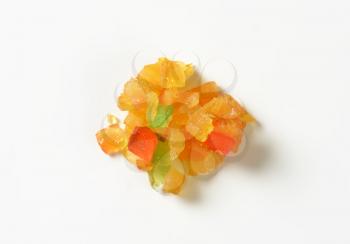 heap of candied fruits on white background