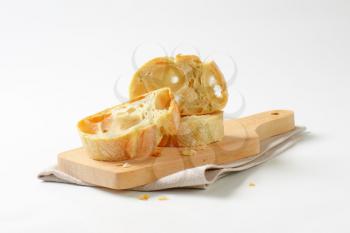 Ciabatta bread slices on cutting board