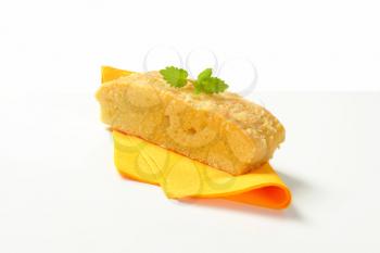 Slice of almond madeira cake on yellow serviette