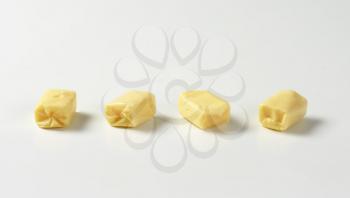 Four milk chewy candies on white background