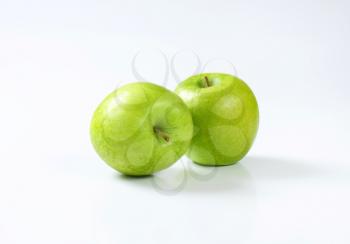 Two fresh ripe green apples
