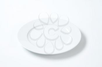 empty white dinner plate with rim