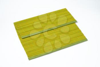 green bamboo place mat on white background