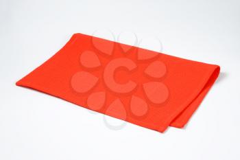 Red cotton place mat folded in half