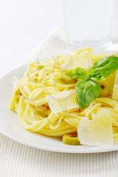 boiled spaghetti with parmesan cheese, green olives and fresh basil