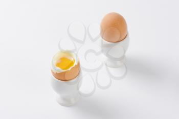 two soft boiled eggs in white eggcups