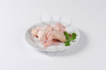 raw chicken wings on plate
