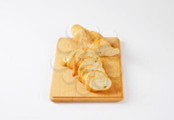 sliced loaf of French bread on cutting board