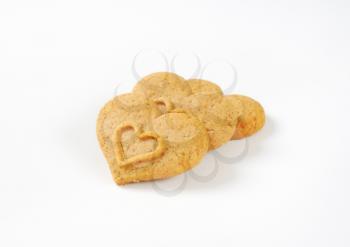 three heart-shaped cookies on white background