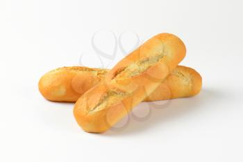 two loaves of French bread on white background