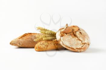 freshly baked bread and baguettes on white background