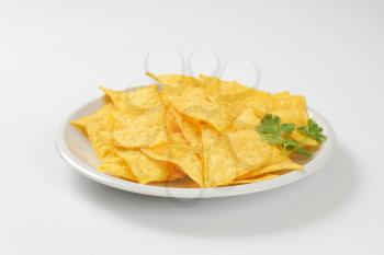 triangle shaped tortilla chips on plate