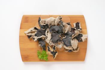 Air dried wood ear mushrooms on cutting board