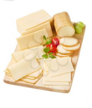 variety of sliced cheeses on wooden cutting board