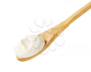 Creme fraiche on a wooden spoon