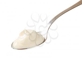 Spoonful of yogurt isolated on white