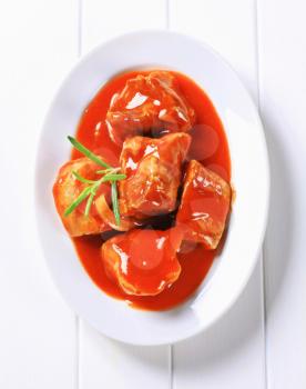 Chunks of pork meat in tomato sauce