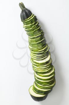 thin slices of fresh zucchini on a white background