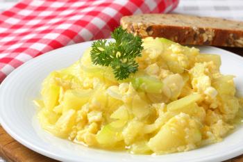 Scrambled eggs with courgette and garlic and slice of whole grain bread