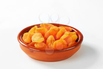 dried apricots in a terracotta bowl
