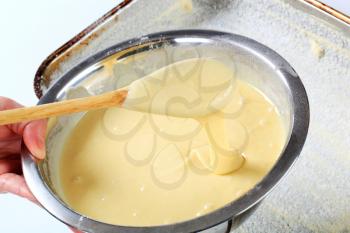 bowl of fresh cake batter ready to be poured into baking pan