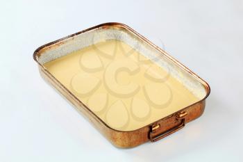 raw cake batter in a baking pan