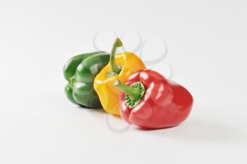 Three fresh bell peppers - red, yellow and green