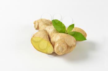 fresh ginger root on off-white background with shadows