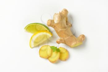 sliced ginger with lemon and lime on white background