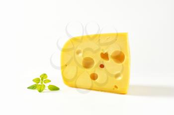 wedge of yellow medium-hard cheese with eyes