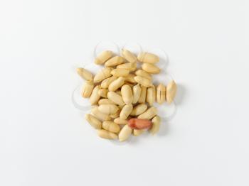Heap of unsalted shelled peanuts