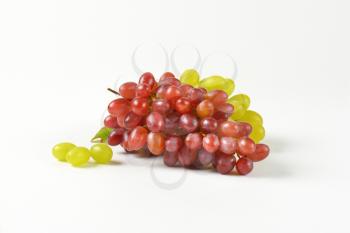 bunches of red and white grapes on white background