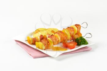 Honey glazed pork skewers with pan fried potato slices