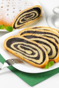 slices of poppy seed roll on white plate