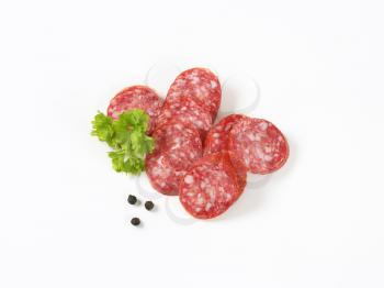 sliced salami sausage on white background