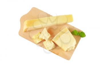 pieces of parmesan cheese on wooden cutting board