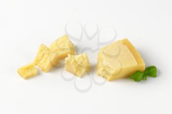 pieces of fresh parmesan cheese on white background