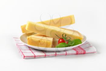three wedges of parmesan cheese on white plate