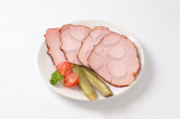 Thin slices of smoked pork roast on plate