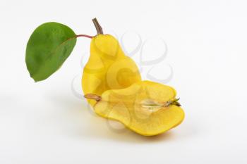 one and half yellow pears on white background