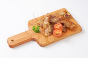 Pan fried side pork bacon on wooden cutting board