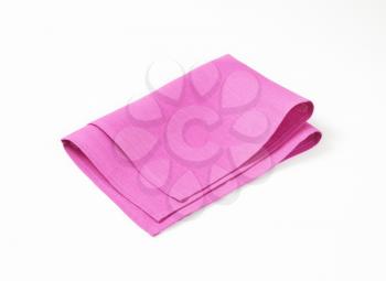 folded purple pink napkin on white background