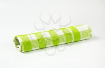 green and white checkered tea towel on white background