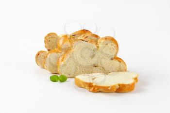 Slices of Christmas sweet braided bread with almonds and raisins