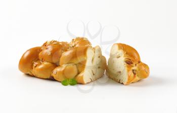 loaf of sweet braided bread on white background