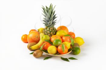 plate of fresh tropical fruit on white background