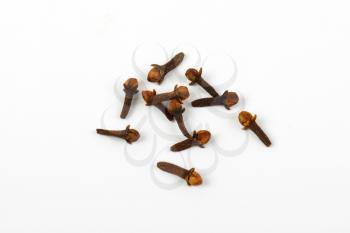 group of dried cloves on white background