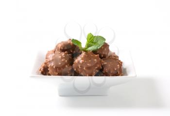 Marzipan squares dipped in chocolate and chopped nuts