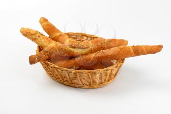 long crunchy bread rolls in a straw basket  bowl